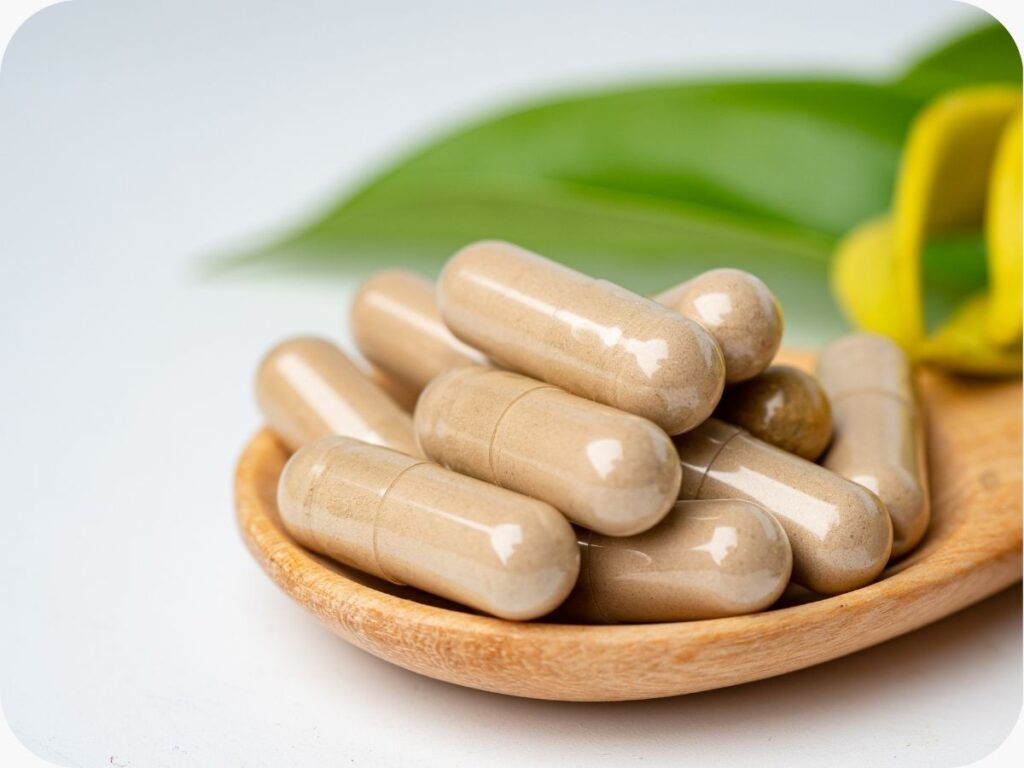 herbal supplements on a wooden spoon