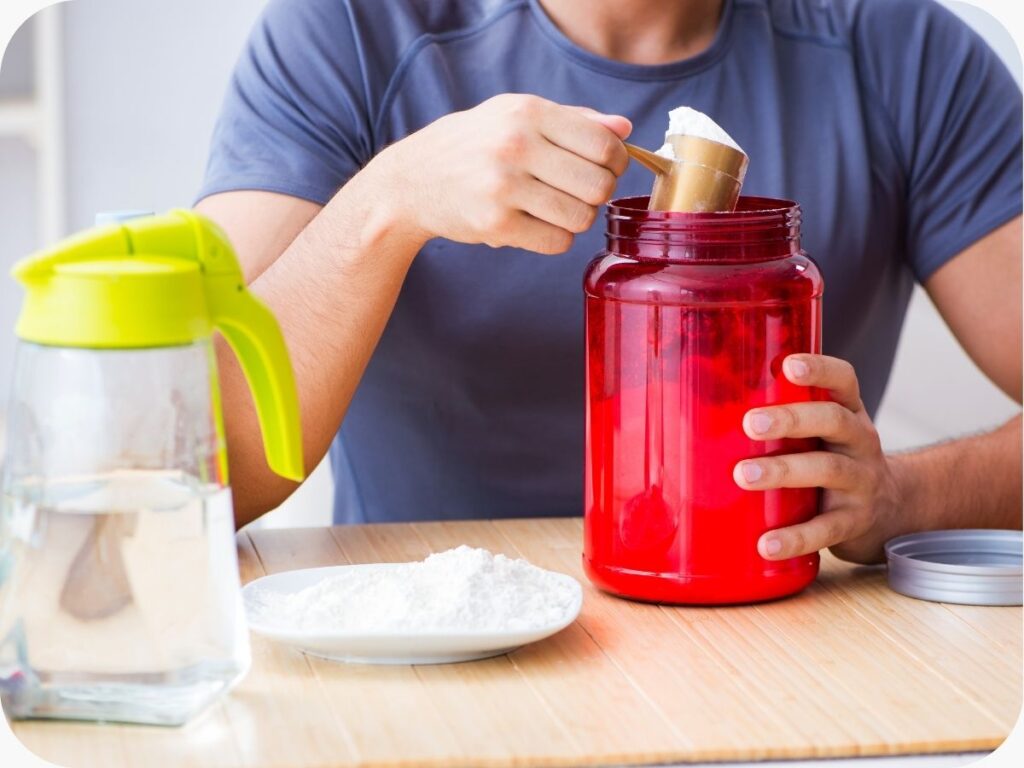 man scooping out protein powder